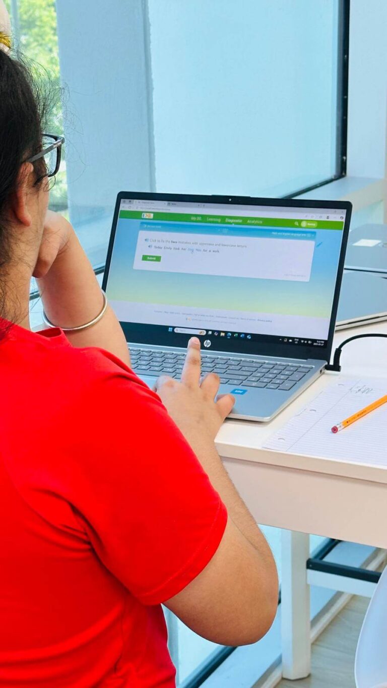Teacher working on laptop preparing notes